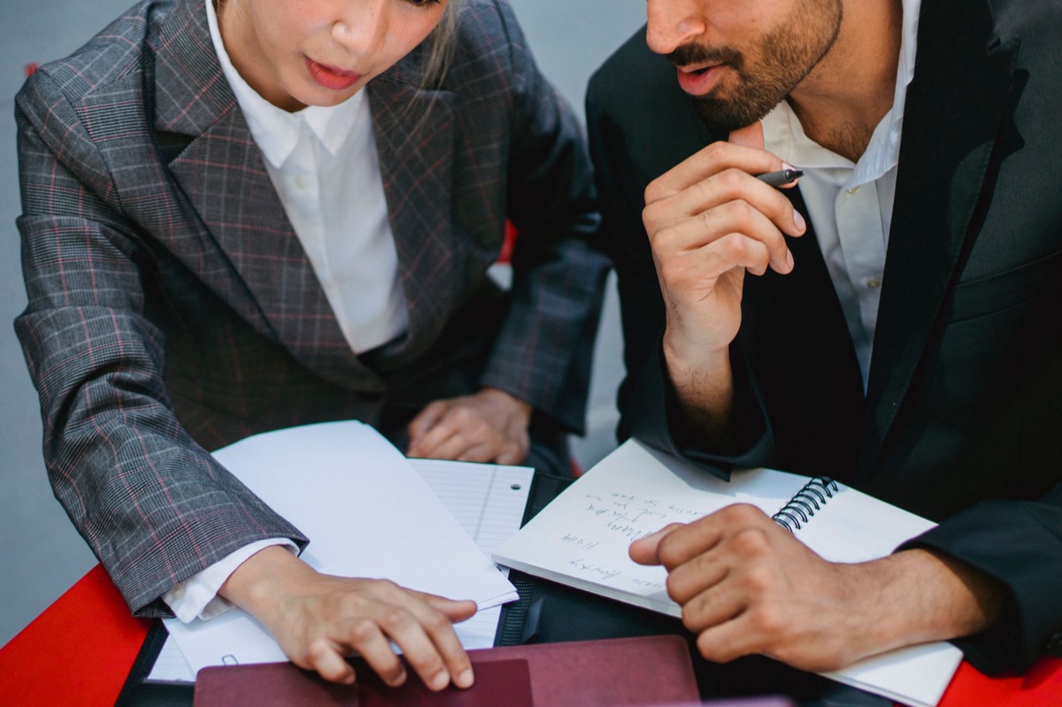 salesperson with notebook and laptop